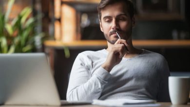 التحيزات المعرفية - رجل يجلس أمام جهاز كمبيوتر محمول